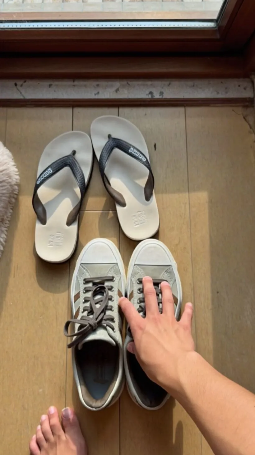 Reaching for closed sneakers instead of the open sandals by the door